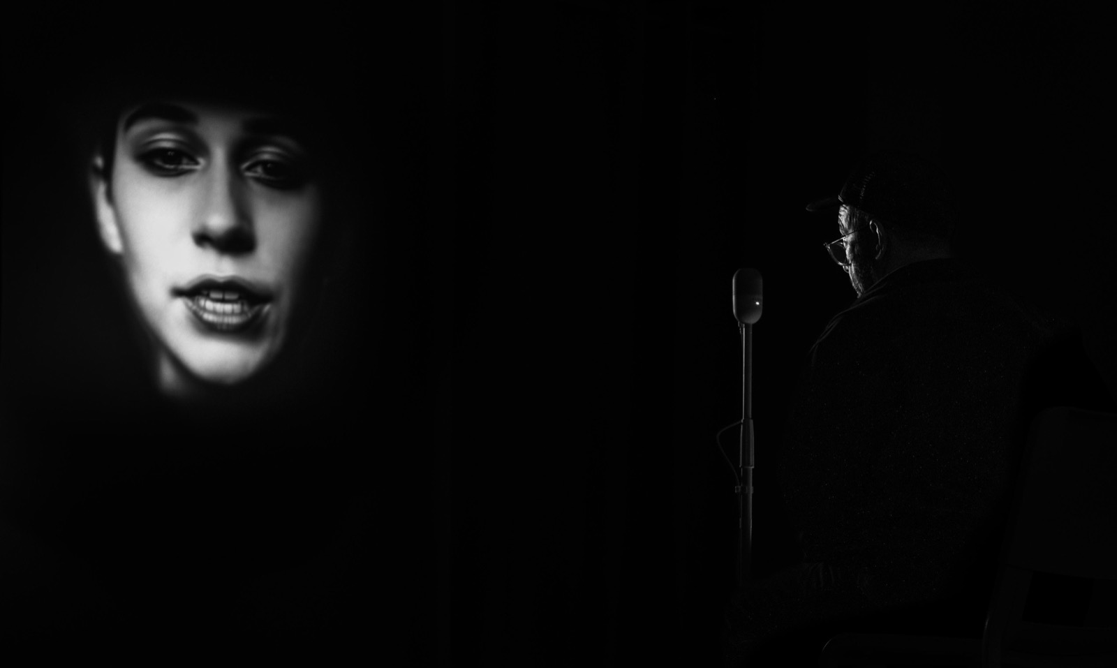 A visitor in conversation with SOLIENNE, projected, at Fotografiska Stockholm